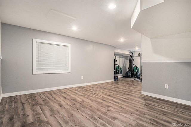 workout area with baseboards, wood finished floors, and recessed lighting