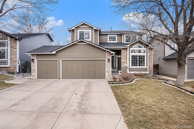 traditional-style house with a garage, a shingled roof, stone siding, driveway, and a front lawn