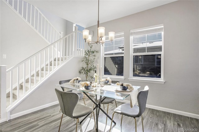 dining room with hardwood / wood-style floors and a chandelier