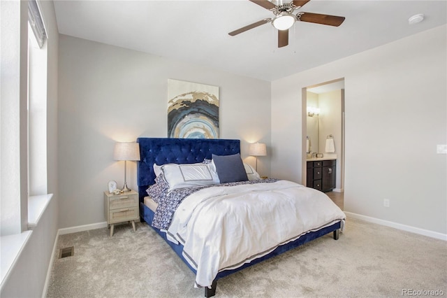 carpeted bedroom with connected bathroom and ceiling fan