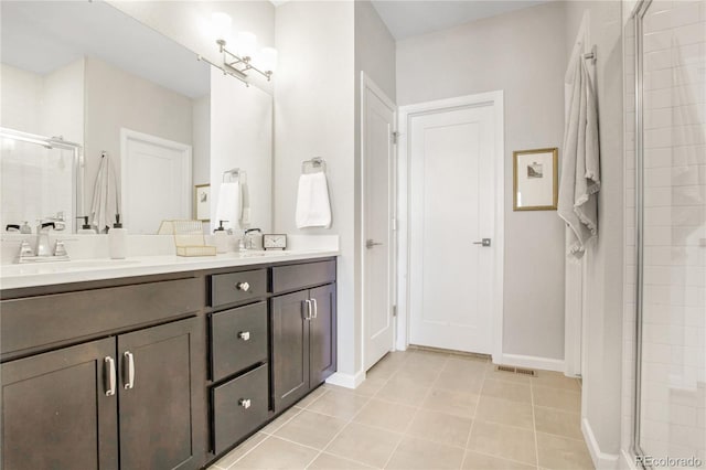 bathroom featuring vanity, tile patterned floors, and walk in shower