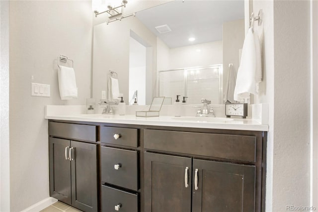 bathroom with vanity, tile patterned flooring, and walk in shower