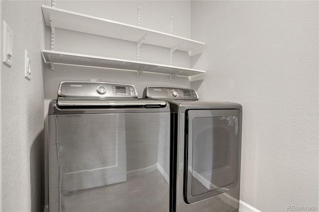 clothes washing area with washer and clothes dryer