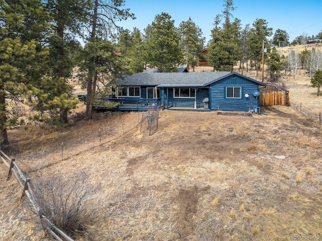 ranch-style house with fence