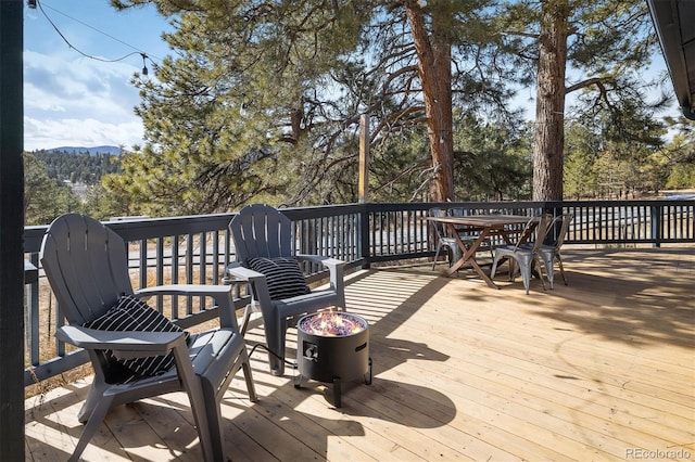 wooden terrace featuring outdoor dining space