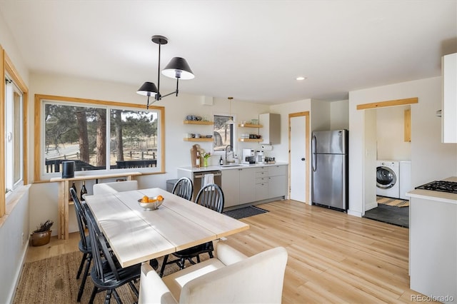 dining area featuring recessed lighting, washer / dryer, and light wood-style floors