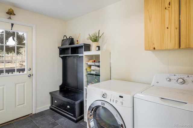 washroom featuring washer and dryer, cabinet space, and baseboards