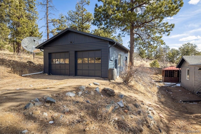 garage with dirt driveway