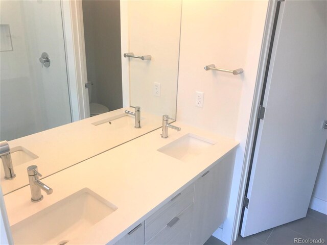 2865 W 24th Ave, Denver, CO 80211 - full bathroom featuring double vanity, a shower with door, and tile patterned flooring