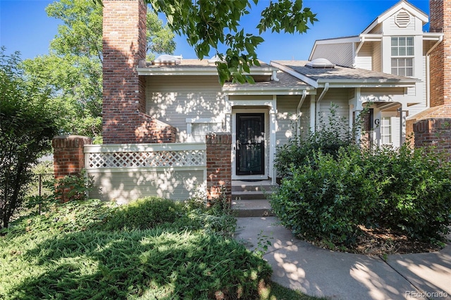2882 W Long Cir Unit H, Littleton, CO 80120 - view of front of home featuring a chimney and brick siding