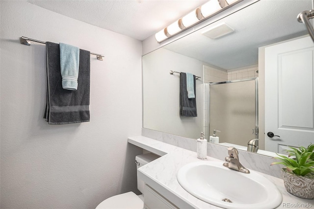 2882 W Long Cir Unit H, Littleton, CO 80120 - bathroom with a shower with door, vanity, and a textured ceiling