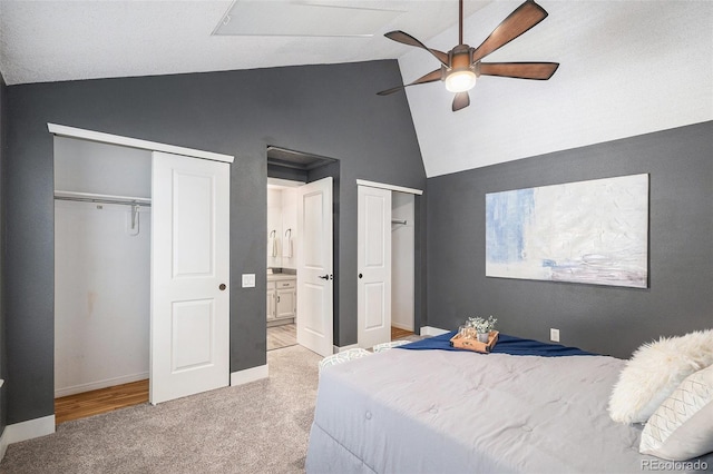 2882 W Long Cir Unit H, Littleton, CO 80120 - bedroom with multiple closets, light carpet, high vaulted ceiling, ensuite bath, and ceiling fan