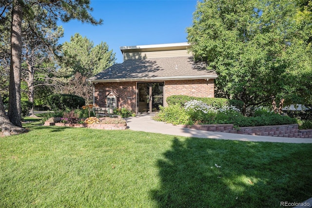 2882 W Long Cir Unit H, Littleton, CO 80120 - rear view of property with a yard and brick siding
