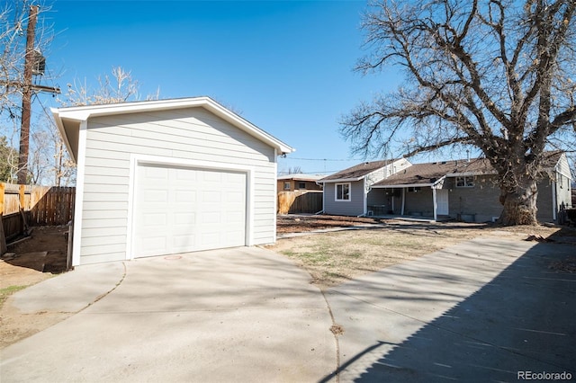 garage with driveway and fence