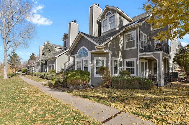 view of front of home with a balcony and central AC