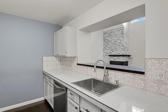 kitchen featuring dishwasher, sink, tasteful backsplash, dark hardwood / wood-style flooring, and white cabinets