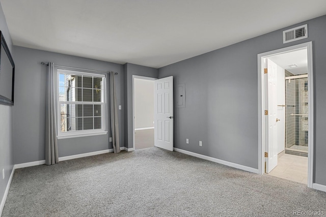 unfurnished bedroom featuring ensuite bath and light carpet