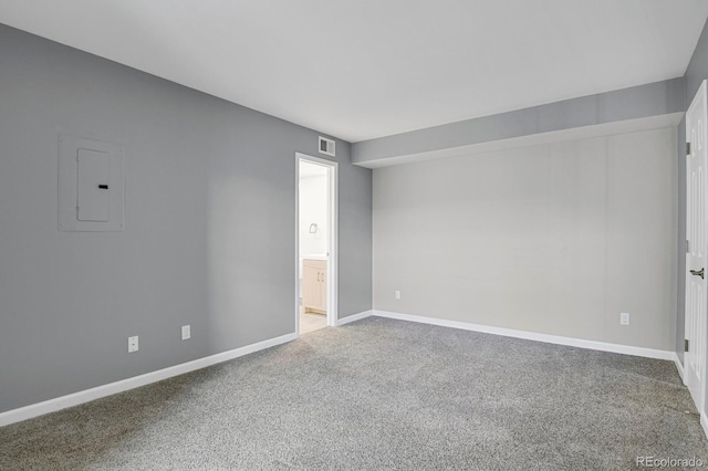 carpeted spare room with electric panel