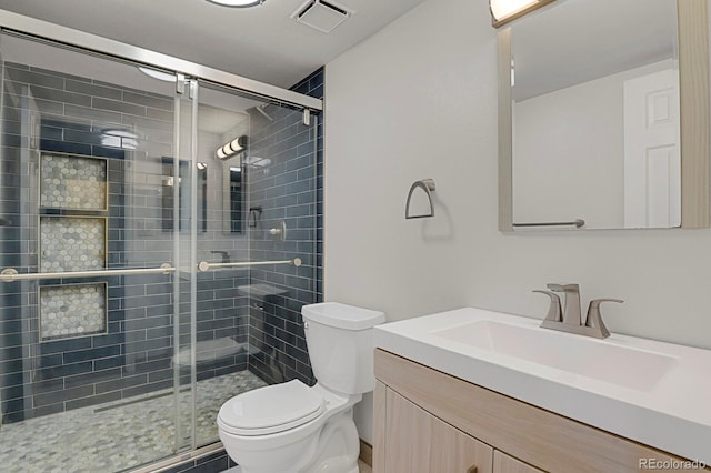 bathroom with vanity, toilet, and walk in shower