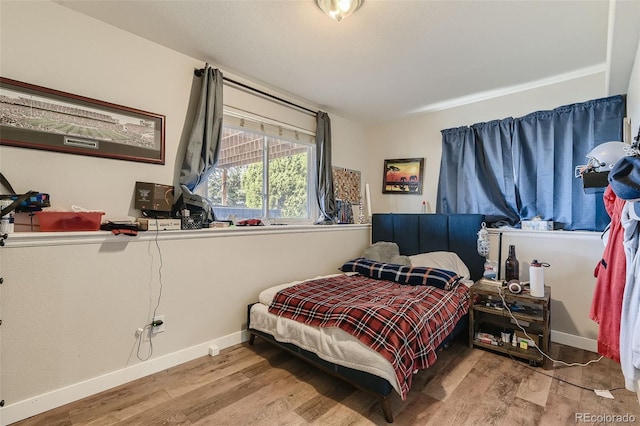 11549 Haskell Creek Rd, Larkspur, CO 80118 - bedroom with wood finished floors and baseboards