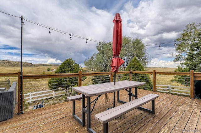 11549 Haskell Creek Rd, Larkspur, CO 80118 - deck featuring outdoor dining space and a view of rural / pastoral area