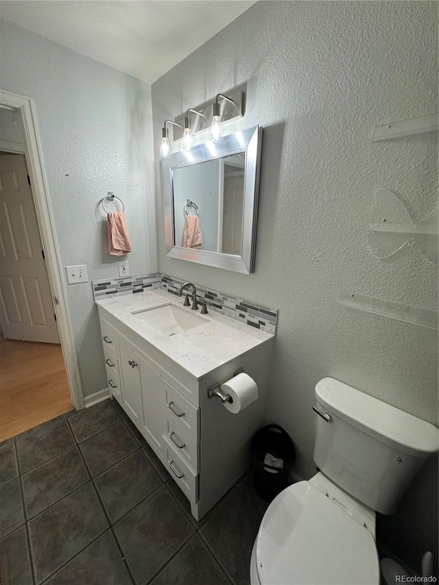 11549 Haskell Creek Rd, Larkspur, CO 80118 - bathroom with vanity, tile patterned flooring, toilet, and a textured wall