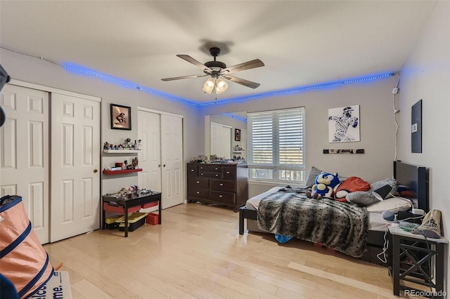11549 Haskell Creek Rd, Larkspur, CO 80118 - bedroom featuring multiple closets, wood finished floors, and ceiling fan