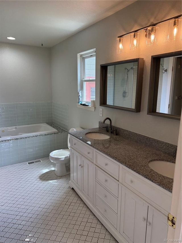 11549 Haskell Creek Rd, Larkspur, CO 80118 - bathroom with double vanity, tiled bath, and toilet