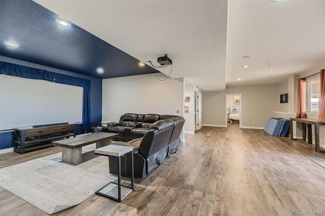 11549 Haskell Creek Rd, Larkspur, CO 80118 - cinema featuring wood finished floors, baseboards, a textured ceiling, and recessed lighting