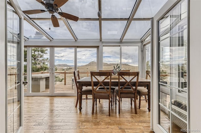 11549 Haskell Creek Rd, Larkspur, CO 80118 - sunroom / solarium featuring hardwood / wood-style flooring, a wall of windows, and a deck with mountain view