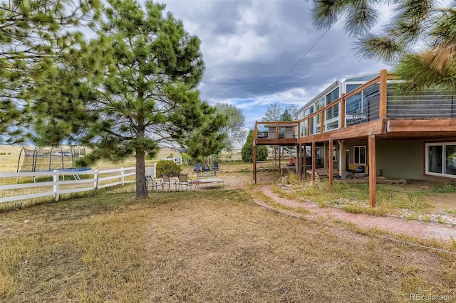 11549 Haskell Creek Rd, Larkspur, CO 80118 - view of yard with a deck and a trampoline