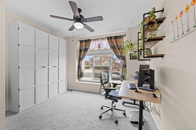 office space with ceiling fan and carpet