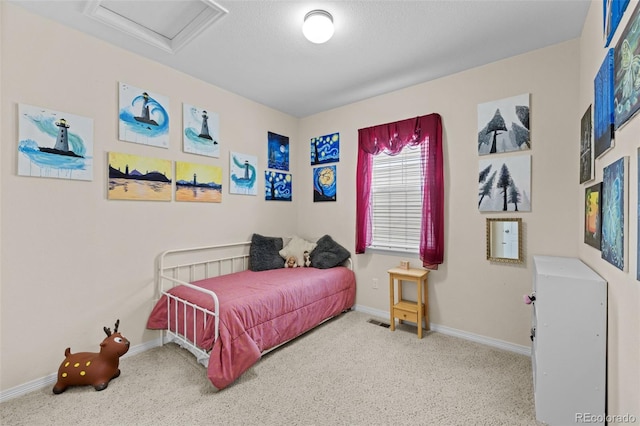 carpeted bedroom featuring a textured ceiling