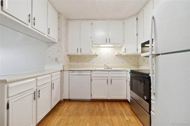 kitchen with white appliances and white cabinets