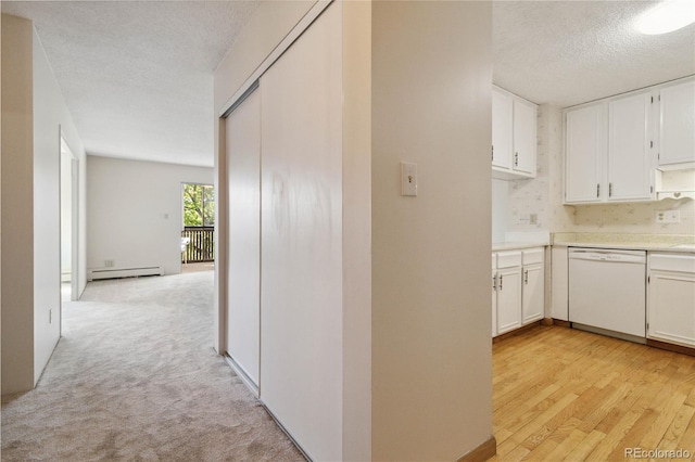 hallway with a textured ceiling, a baseboard radiator, and light hardwood / wood-style flooring