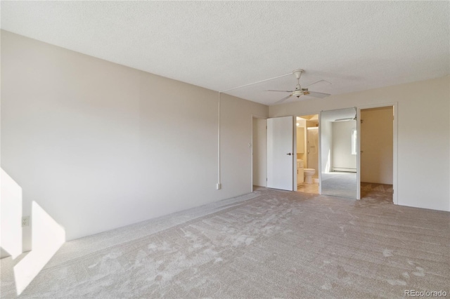 carpeted empty room with a ceiling fan and a textured ceiling