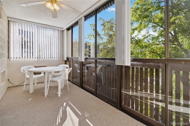 sunroom featuring ceiling fan