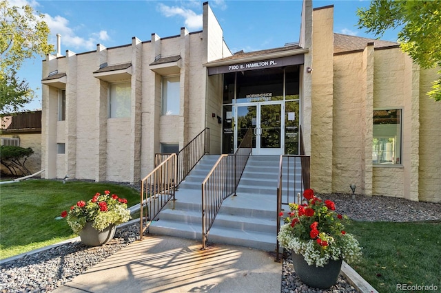 property entrance with a yard