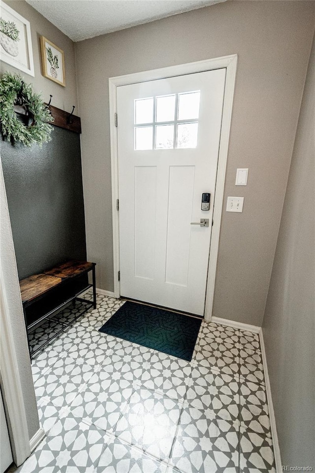 1699 S Trenton St Unit 69, Denver, CO 80231 - mudroom featuring tile patterned floors and baseboards