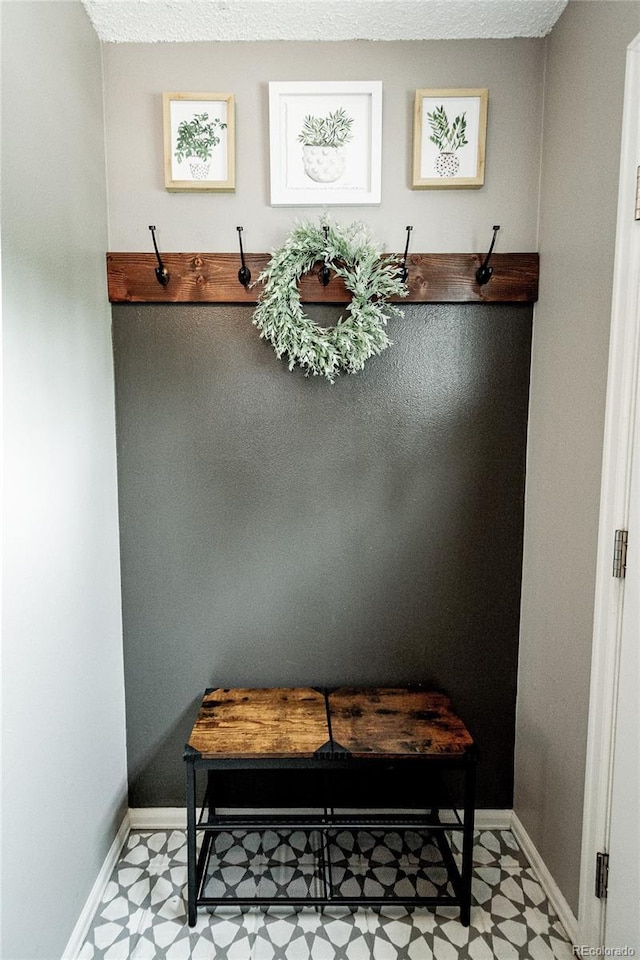 1699 S Trenton St Unit 69, Denver, CO 80231 - mudroom featuring tile patterned floors and baseboards
