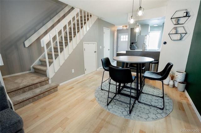 1699 S Trenton St Unit 69, Denver, CO 80231 - dining room featuring stairway and wood finished floors