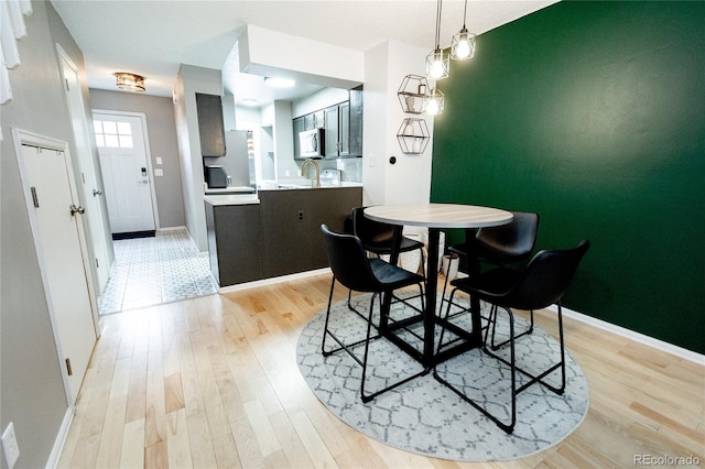 1699 S Trenton St Unit 69, Denver, CO 80231 - dining space featuring light wood finished floors and baseboards