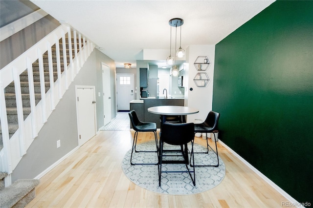 1699 S Trenton St Unit 69, Denver, CO 80231 - dining room featuring stairs and light wood-style floors