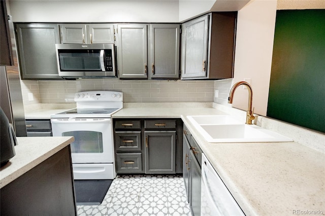 1699 S Trenton St Unit 69, Denver, CO 80231 - kitchen with white appliances, light countertops, and tasteful backsplash