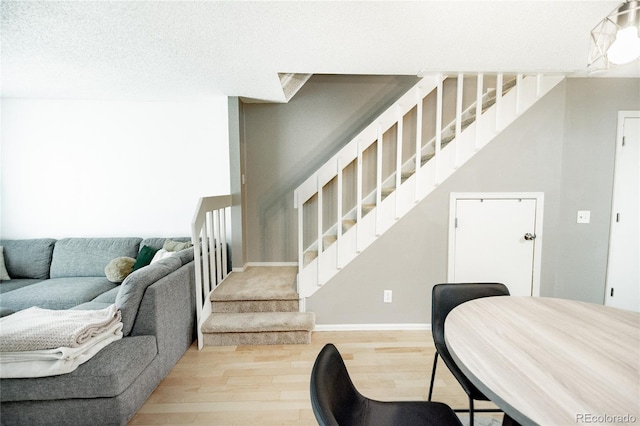 1699 S Trenton St Unit 69, Denver, CO 80231 - living room featuring stairway and wood finished floors