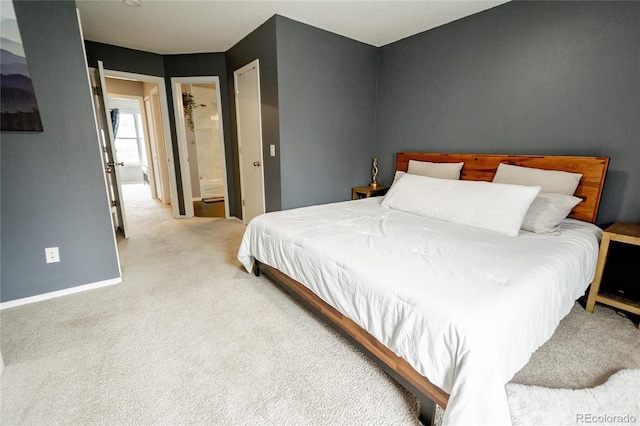 1699 S Trenton St Unit 69, Denver, CO 80231 - carpeted bedroom featuring baseboards and connected bathroom