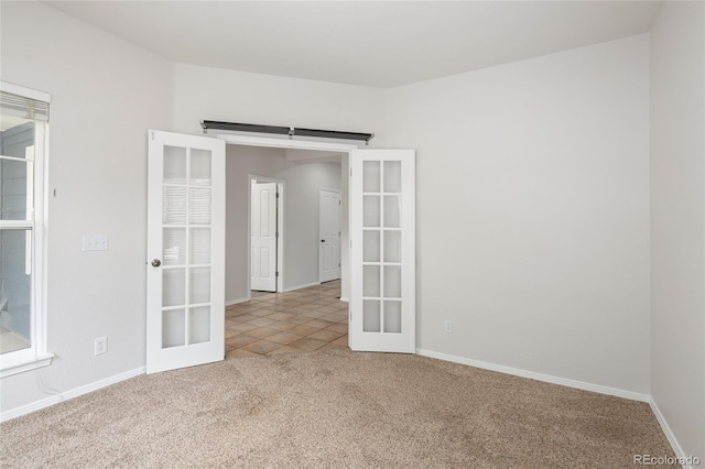 4488 Larksong Pl, Castle Rock, CO 80109 - carpeted spare room with french doors and tile patterned floors