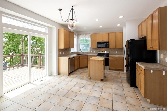 4488 Larksong Pl, Castle Rock, CO 80109 - kitchen featuring black appliances, light tile patterned floors, tasteful backsplash, a center island, and recessed lighting