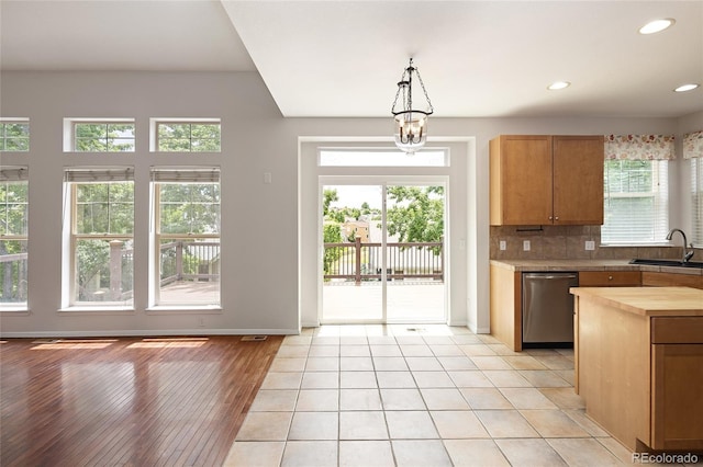 4488 Larksong Pl, Castle Rock, CO 80109 - kitchen featuring stainless steel dishwasher, healthy amount of natural light, butcher block counters, backsplash, and recessed lighting