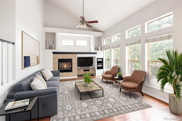 4488 Larksong Pl, Castle Rock, CO 80109 - living room featuring high vaulted ceiling, hardwood / wood-style floors, ceiling fan, and a tile fireplace